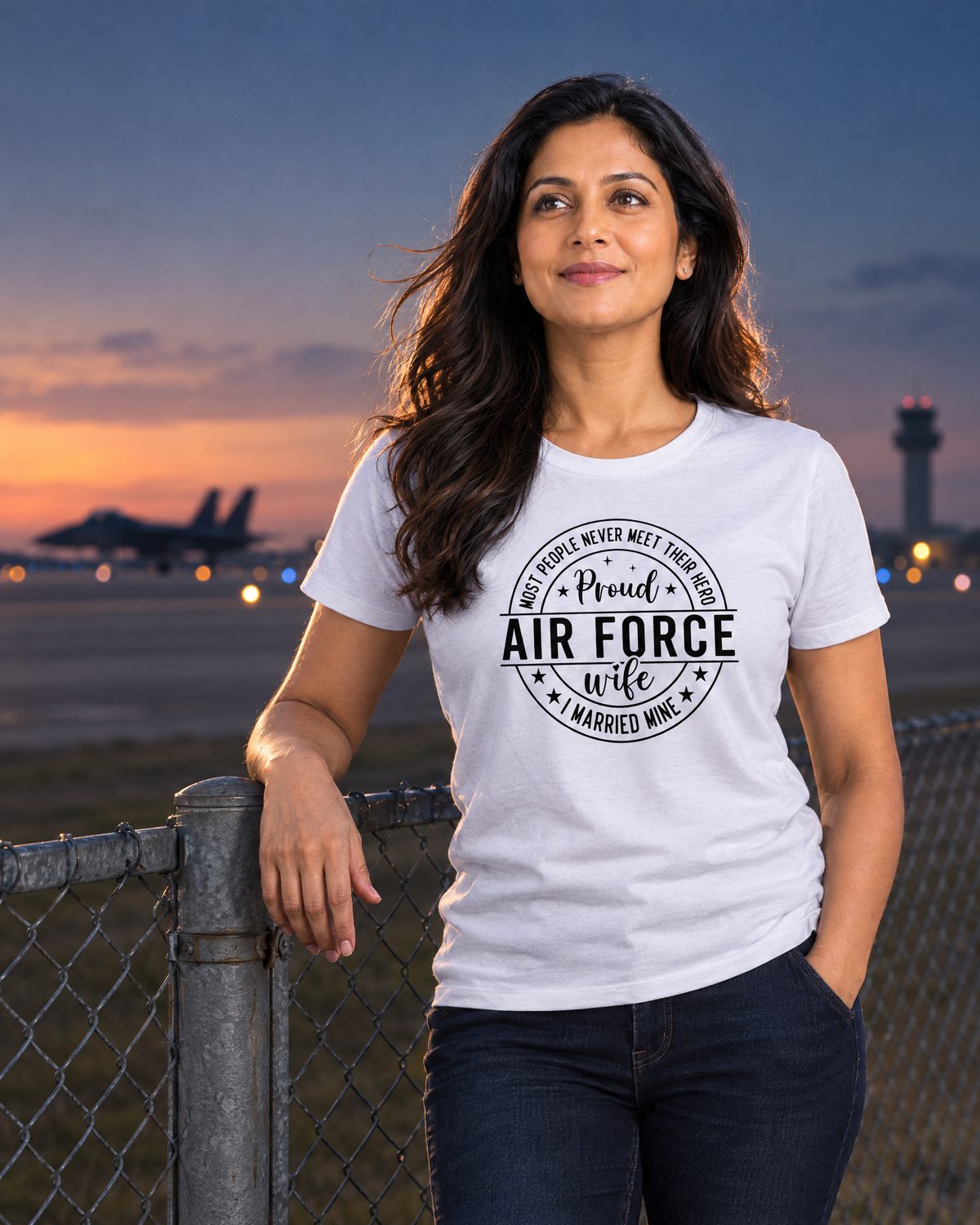 Woman at the edge of an airfield at dusk wearing the Proud Air Force Wife tee